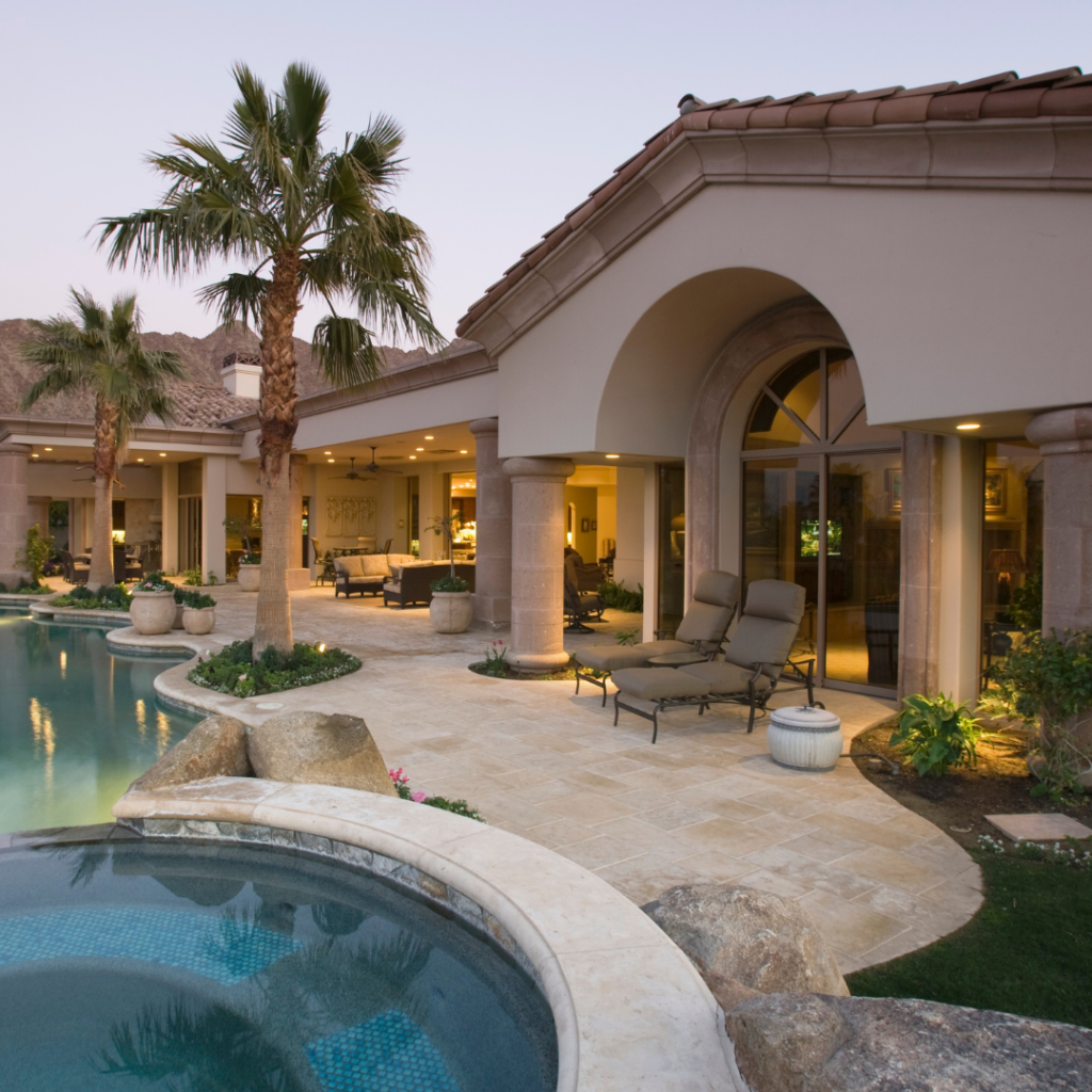 Backyard pool of a luxury southern style home at dusk